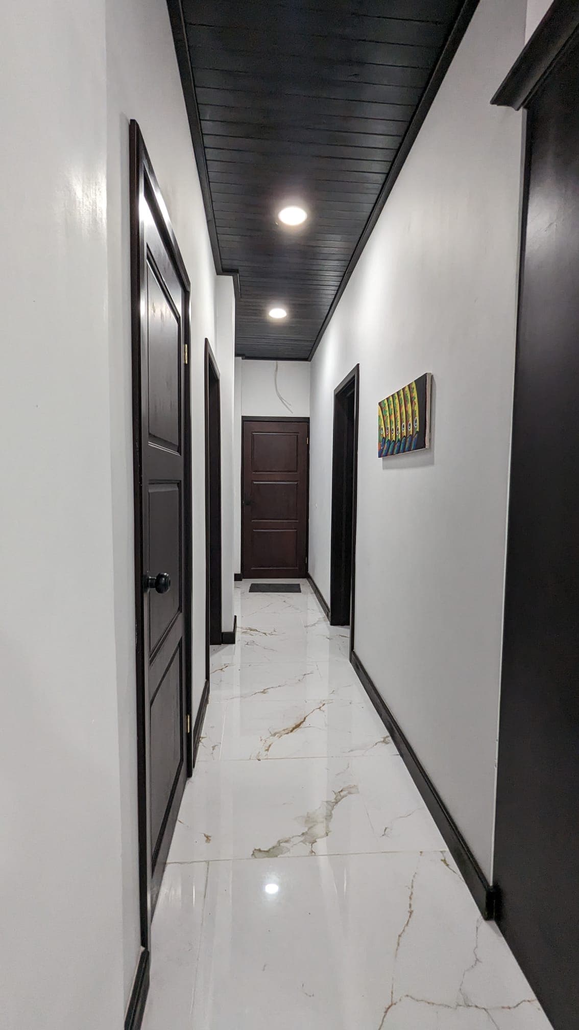 Hallway to second and third bedrooms/bath