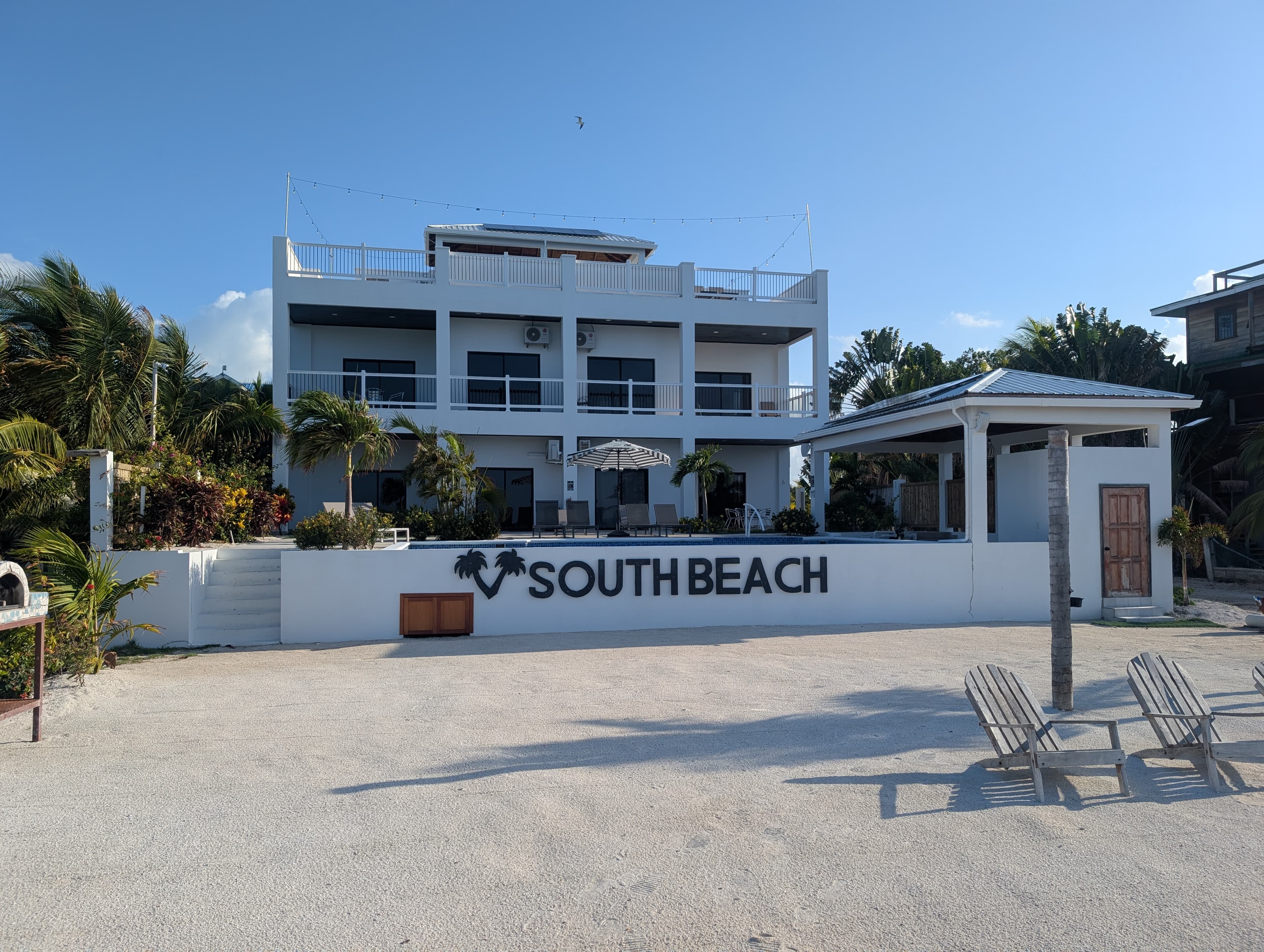 beachfront view, white sand and 4 condos with southbeach wording on the front pool