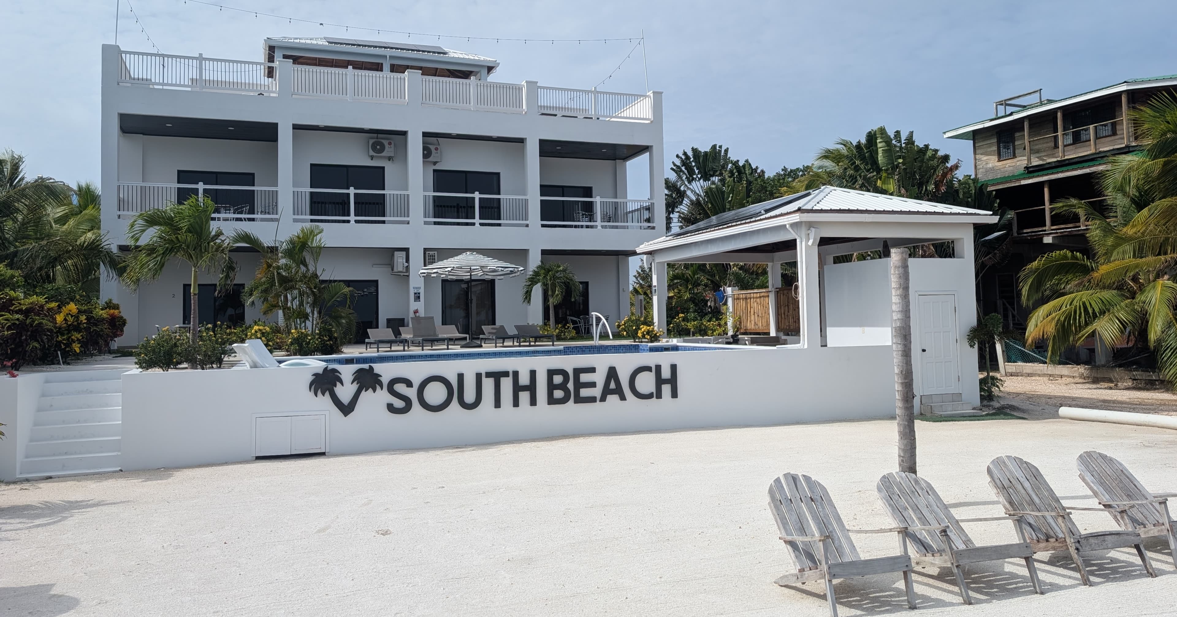 Two story building with 4 luxury condos, all beach front, with beachfront pool, beach and dock.