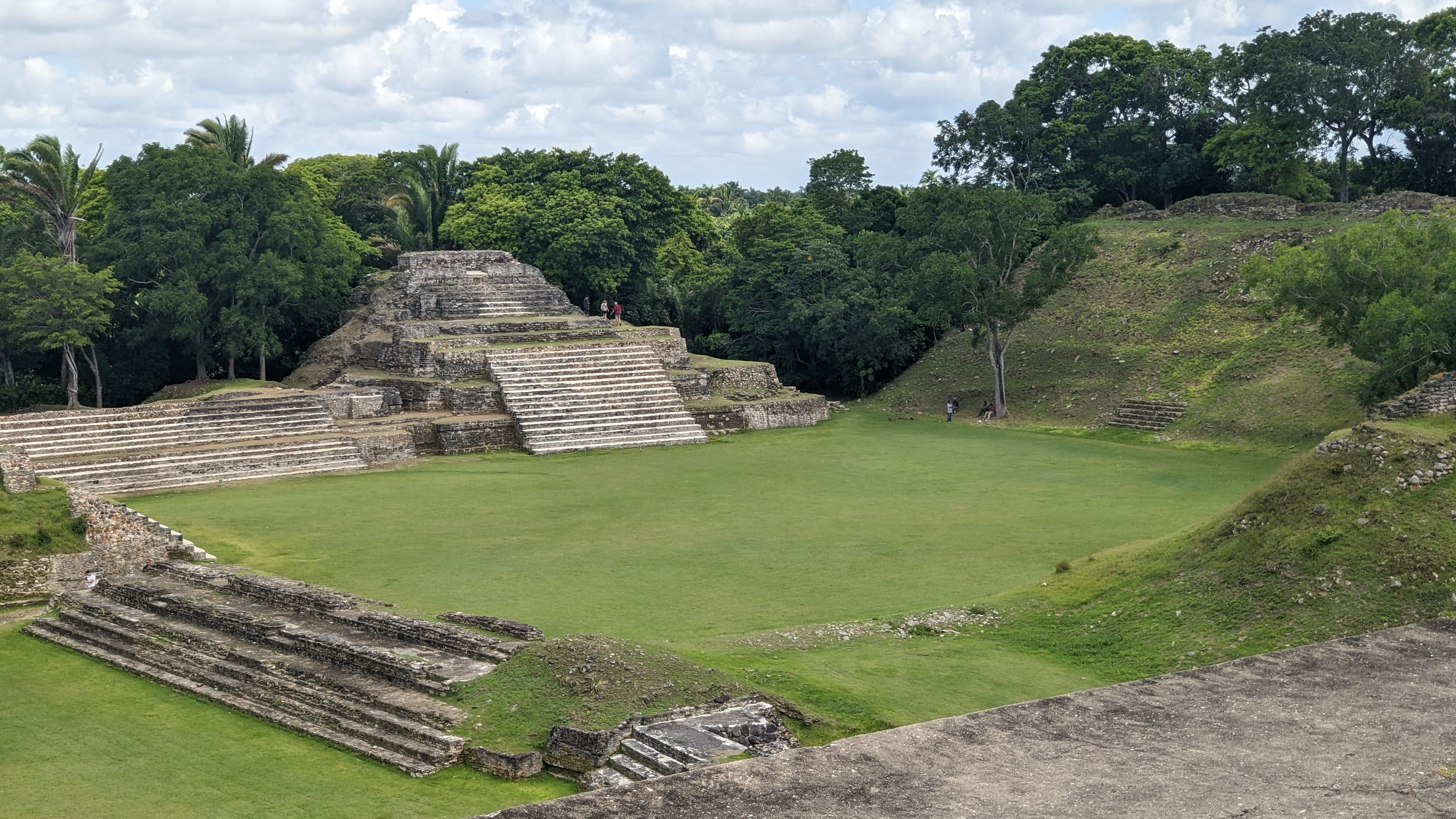 Ancient stone structures and steps surrounded by lush greenery.
